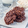 Flourless no bake peanut butter and oatmeal chocolate cookies with glass of milk, square format