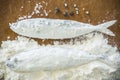 Floury fish on a wooden background