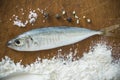 Floury fish on a wooden background