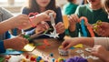 Children engaging in a crafting activity, using scissors, paper, glue, and various colorful materials Royalty Free Stock Photo
