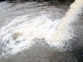 Flow out water from the conduit of Industrial factory to the river Royalty Free Stock Photo