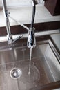 Flow of water in a metal sink on a modern kitchen Royalty Free Stock Photo