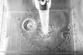 Flow of water in a metal sink on a modern kitchen Royalty Free Stock Photo