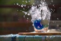 flow of water poured into a glass forming splashes