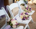 Roses flower arraignment on white chairs outdoors afternoon Royalty Free Stock Photo