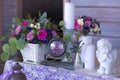 Flower arrangement in a basket decorate the wedding table in purple tones. Vintage. Flowers, candles, clocks.