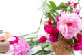 Flower arrangement with a beautiful bouquet of pink peony flowers, cornflowers and red roses on a white background with space for Royalty Free Stock Photo