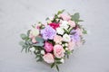 Flower arrangement in a box with spray pink roses, succulent, eustoma, white hypericum, eucaliptus