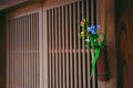 Flower arrangement outside Japanese doors Royalty Free Stock Photo