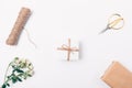 Flower arrangement of small present box, rose branch, twine and scissors, top view. Flat lay arrangement of decorative items for Royalty Free Stock Photo