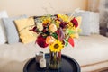 Flower arrangement on table. Close up of fall bouquet of sunflowers dahlias roses and zinnias in vase at home Royalty Free Stock Photo