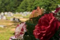 Subdued red flower arrangement bouquet at cemetery