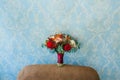 Flower arrangement for a wedding party. The bouquet of pink roses, red peonies, and other flowers on blue wall Royalty Free Stock Photo