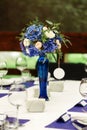 Flower arrangement on wedding table. Floral compositions with fresh roses and blue flowers Royalty Free Stock Photo