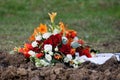 flower arrangement with roses and fire lilies on grave Royalty Free Stock Photo