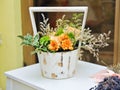 Flower arrangement in white vintage pot. Wedding decoration with yellow flowers Royalty Free Stock Photo