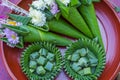 Flower in the banana leaf cones with joss-sticks and candle for pray. Northern Thailand culture