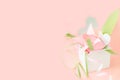 Flower banner. Composition of pink Origami paper tulip with green decorations in white box-heart on pink background Royalty Free Stock Photo