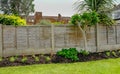 Flower bed in the back-garden with a fence behind the plants. Royalty Free Stock Photo