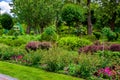 Flower bed with bushes and blossom flowers. Royalty Free Stock Photo