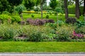 Flower bed with bushes and flowers in a park. Royalty Free Stock Photo