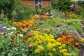 flower bed overflowing with colorful blooms and vegetable garden brimming with bounty Royalty Free Stock Photo