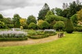 Flower beds and a bench in outdoor gardens at Crathes Castle estate, Scotland Royalty Free Stock Photo