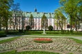 Flower beds with colorful flowers in front of the building of the former baroque monastery