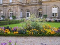 Flower beds and gravel walk in front of French Senate building,