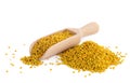 Flower bee pollen and a wooden slove is isolated on a white background. Natural remedy for immunity enhancement