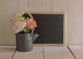 Flower in a black tea pot with black drawing board. Royalty Free Stock Photo