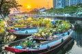 Flower boats full of flowers parked along canal wharf in sunset Royalty Free Stock Photo