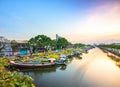 Flower boats full of flowers parked along canal wharf in sunset Royalty Free Stock Photo