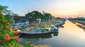 Flower boats full of flowers parked along canal wharf in sunset Royalty Free Stock Photo