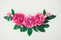 Flower border composition made of bright pink buds peony bouquet on a white wooden background. Floral texture mockup. Flat lay, Royalty Free Stock Photo