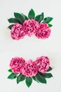 Flower border frame made of bright pink buds peony bouquet on a white wooden background. Floral texture mockup. Flat lay, top view Royalty Free Stock Photo