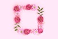 Flower border frame made of of rose, aster and alstroemeria on a pink background