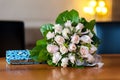 Flower bouquet and turquoise purse on wood table Royalty Free Stock Photo