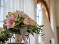 Flower bouquet in a vase under the lights surrounded by windows with a blurry background Royalty Free Stock Photo