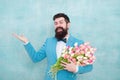 Flower bouquet for womens day. Bearded man with tulips. Flowers shop. Ideas to celebrate without breaking bank. Spring Royalty Free Stock Photo