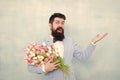 Flower bouquet for womens day. Bearded man with tulips. Flowers shop. Ideas to celebrate. Spring mood. Love date. Gift