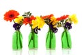 Flower bouquets in green bottles