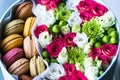 Flower box with flowers and macarons composition closeup Royalty Free Stock Photo