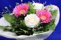 A flower bunch with white roses and pink gerbera