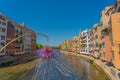 Flower at the colorful yellow and orange houses and famous house Casa Maso at the river Onyar in Girona