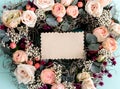 Flower composition of delicate pink roses with a blank note. Flat lay, copy space Royalty Free Stock Photo