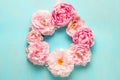 Flower composition. Frame made of pink peony flowers on blue wooden background with copy space. Flat lay Royalty Free Stock Photo