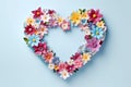 Flower composition. Heart symbol made of multi colored flowers on a light background. Flat lay, top view. copy space Royalty Free Stock Photo