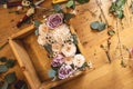 Flower composition in a wooden box on the florist`s desktop. Spring bouquet of roses in pastel colors in flower shop Royalty Free Stock Photo