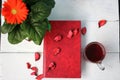 Flower with a cup of tea and a book on a white table Royalty Free Stock Photo